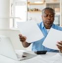 african american retired man reviewing taxes