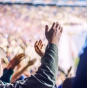 Football fans clapping on the podium