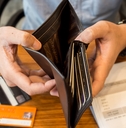 man showing empty wallet debt concept