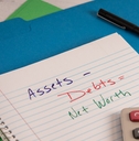 net worth accounting equations on notebook
