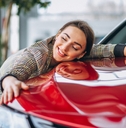 Woman hugging a car