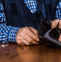 senior man showing an empty wallet without money