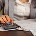 business woman calculating taxes at work