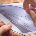 Businessman Opening Envelope With Paycheck