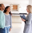 happy Female Realtor Showing Couple new House