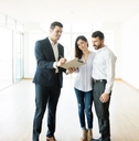 Realtor Explaining Agreement To Couple In Apartment