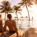 couple enjoying beach vacation at tropical resort 