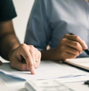 men and women together analyzing expenses 