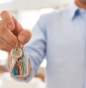 Man holding keys of his house