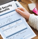 woman reading Social Security Benefits Form Concept