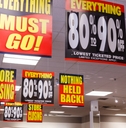 huge discount signs displayed at closing store