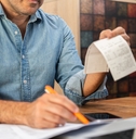 middle-aged man calculating taxes