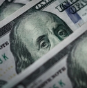 Several one hundred dollar bills at table