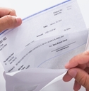 Businessman opening envelope with paycheck