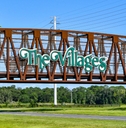 the Villages sign over Steel bridge
