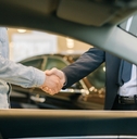 Buyer of car shaking hands