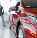 Couple buying new red car