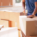 man packing boxes for move