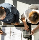couple calculating bills together at home