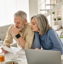 Retired couple reviewing bills together at home 