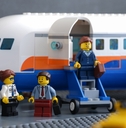 Lego businesspeople minifigures besides private jet
