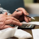 Senior woman checking bills at home