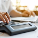 businessman pressing on calculator