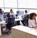 workers in busy open plan office 