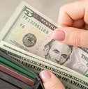 woman gets american money from the wallet