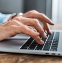 senior woman typing on laptop