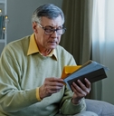 Caucasian man checking sorting letters in living room