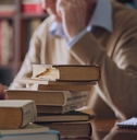 senior historian reading literature at the library