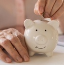 putting money coins in a piggy bank
