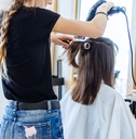 woman drying hair in hair salon 