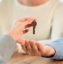 cropped image of happy mature couple getting keys