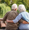 Mature couple resting near lake
