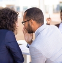 employees gossiping about young female colleague