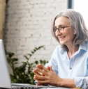 senior businesswoman sitting at the desk using laptop