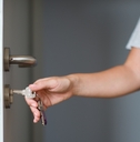 hands opening a door with keys