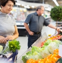 female customer selects savoy cabbage