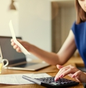 woman using laptop and calculator