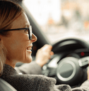 Smiling woman driving a car