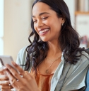 Woman smiling while using smartphone