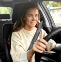 Smiling woman driving a car