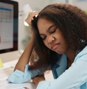 tired manager touching her head