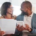 Happy man and woman with paperwork, budget and retirement fund with investment