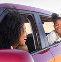 Happy mother and daughter in a car