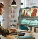 Female Video Editor Works with Footage in Work Office