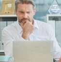 businessman thinking infront of laptop