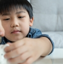 children putting coin for saving